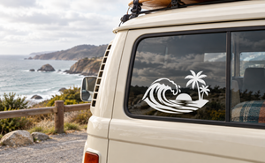 White surf wave and palm tree vinyl decal on car window