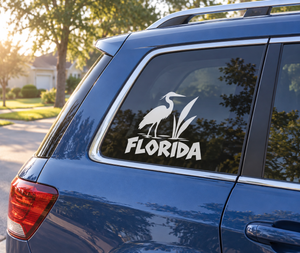Vinyl decal of a white heron with FLORIDA text on a car rear window