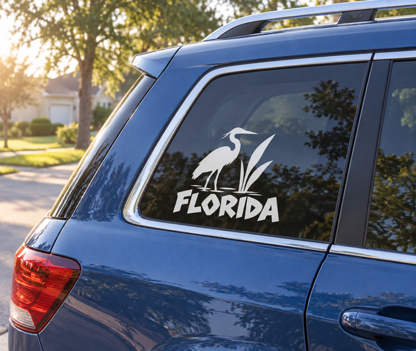 Vinyl decal of a white heron with FLORIDA text on a car rear window