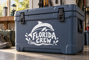 White Florida Crew vinyl decal with dolphin and ocean wave accents on a blue cooler