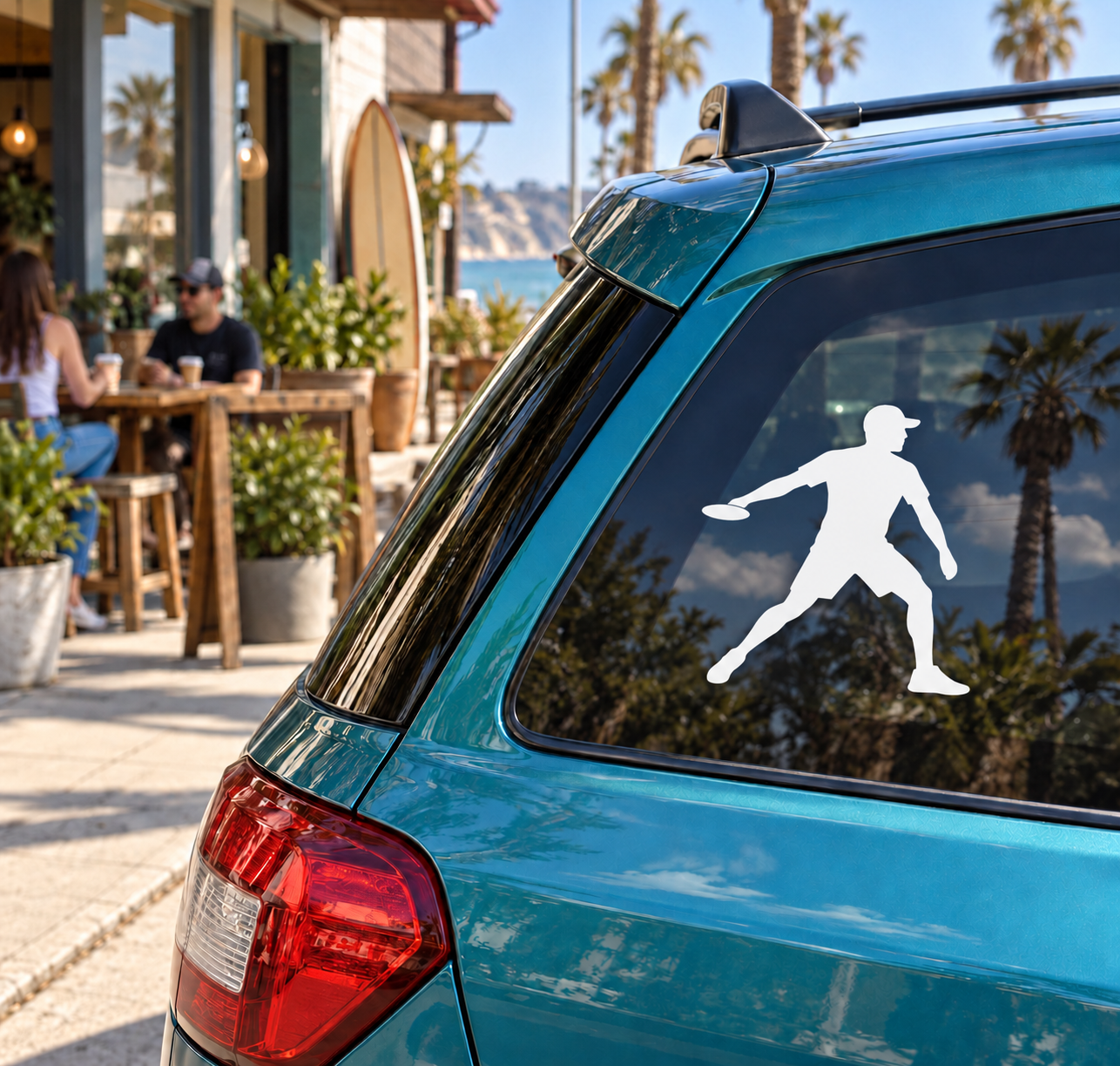 White flying disc forehand player vinyl decal on blue car rear window