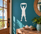 Vinyl wall decal of a person catching a flying disc overhead, white silhouette
