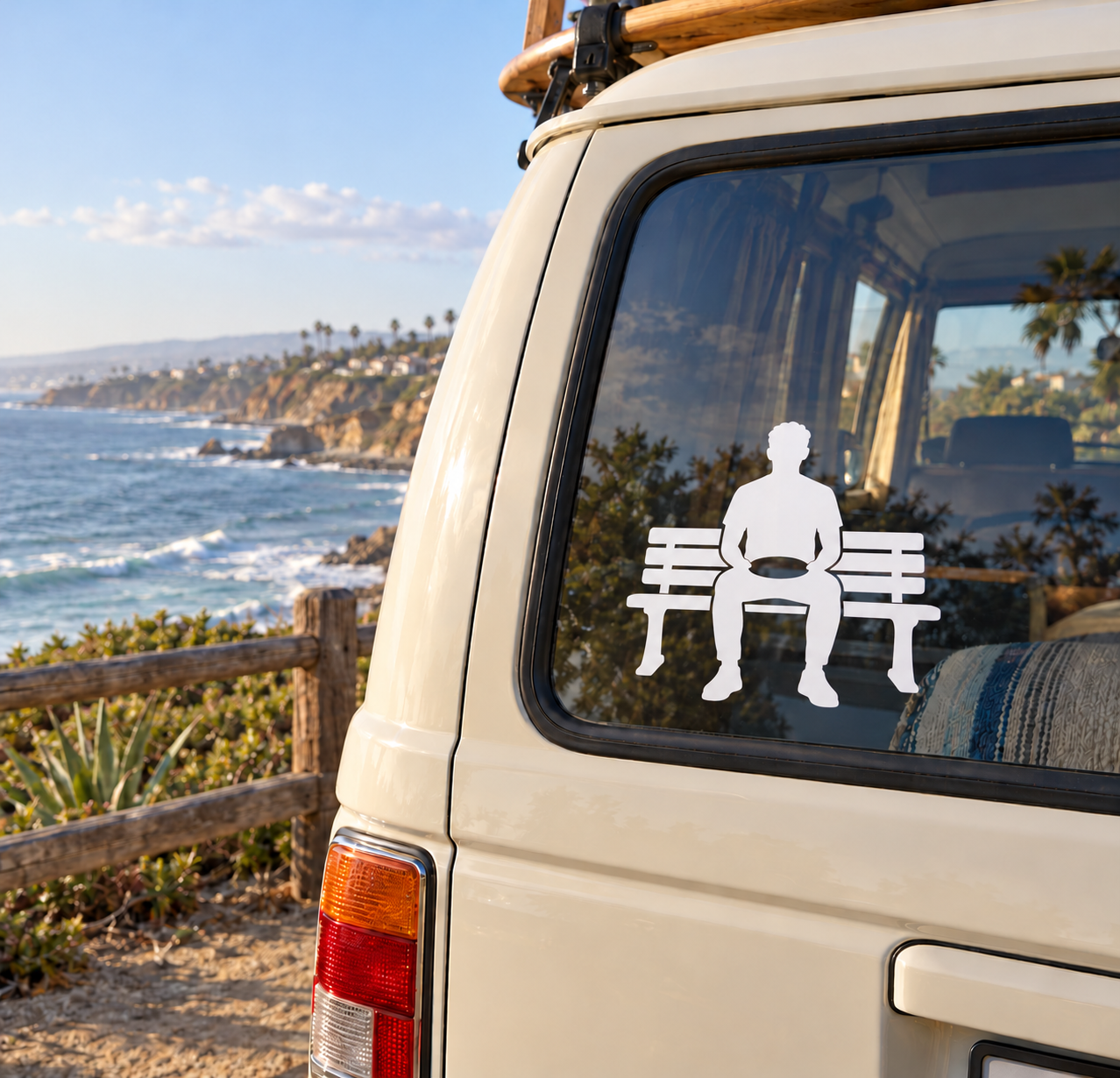 White vinyl decal of seated person on bench for car window
