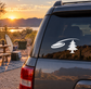 Flying disc and pine tree vinyl decal on dark car rear window