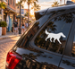 White dog with flying disc vinyl decal on car rear window