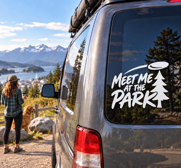 Vinyl decal with “Meet Me at the Park” text and pine tree on car window
