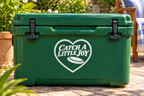 Catch a Little Joy vinyl decal with heart outline, black text, and flying disc icon