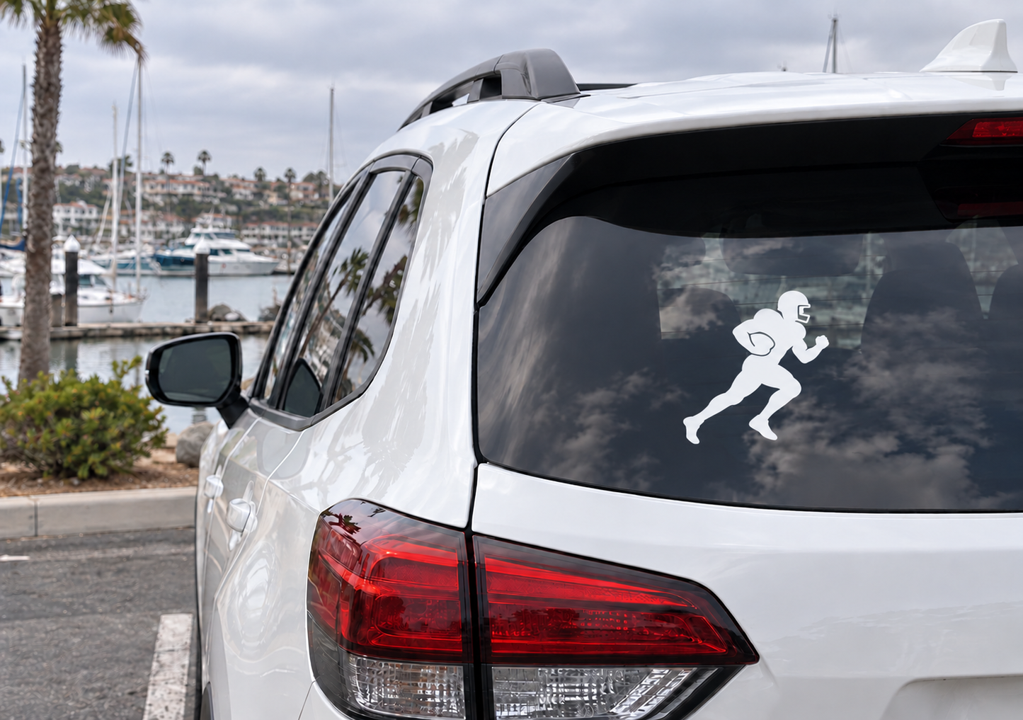 Football player running forward vinyl decal on car rear window, white figure