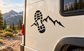 Black vinyl decal of boot footprint and mountain ridge on a vehicle panel