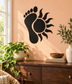 Black vinyl footprint and sun decal with circular center and spiky rays