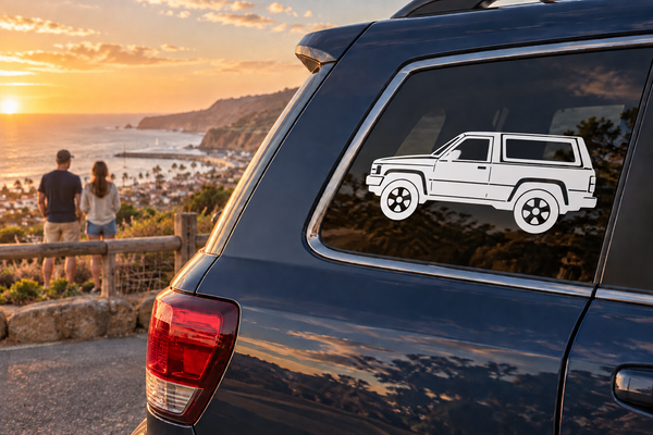 White vintage truck vinyl decal on dark vehicle rear side window