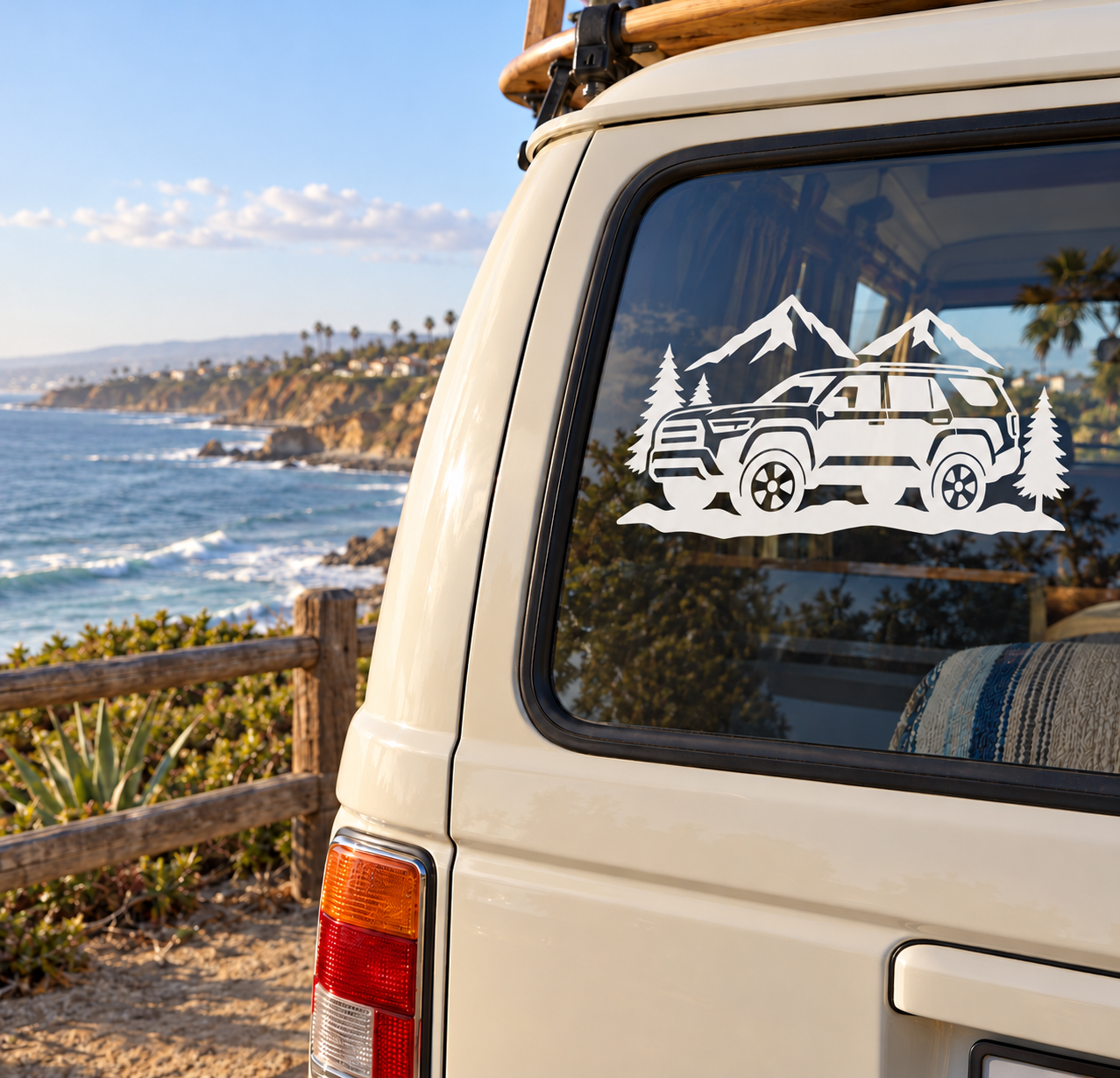 Vinyl car window decal of a white off-road SUV with mountains and pine trees
