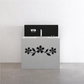 Black daisy-style floral vinyl decal with three blossoms on furniture drawer front