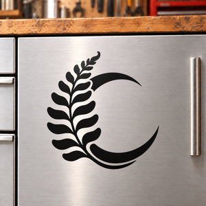 Black vinyl decal of a crescent moon with leafy branch design