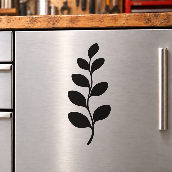 Black eucalyptus leaf sprig vinyl decal for furniture panels, centered on metal surface