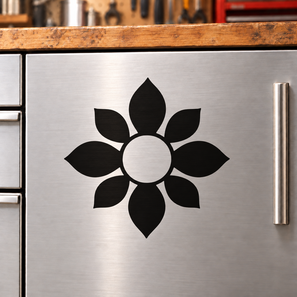 Petal medallion vinyl decal with black flower shape and white center on metal surface