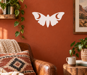 Glow-in-the-dark vinyl moth decal, white silhouette on wall