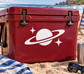 Red vinyl decal with white Saturn and star accents for glow-in-dark signage