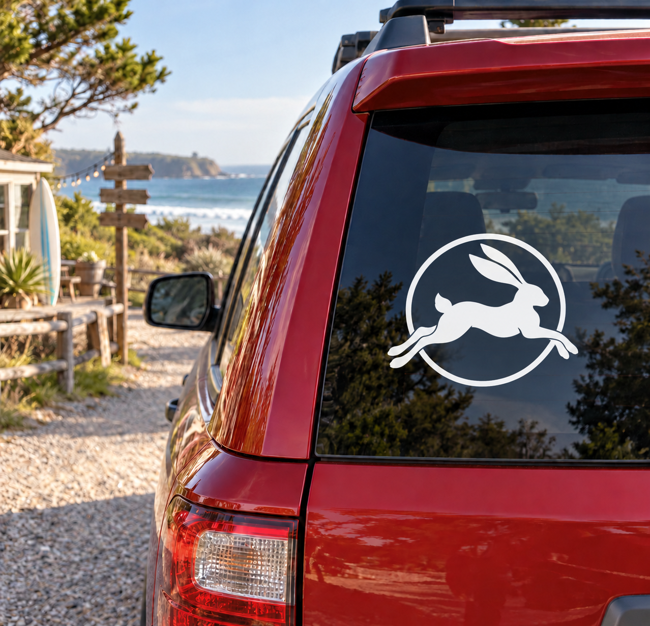 Glow-in-the-dark vinyl hare decal on car window, white hare in circular emblem
