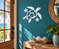 Glow-in-the-dark turtle vinyl decal with stars and shell, white design on teal wall