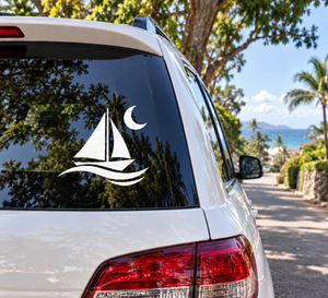 Glow-in-the-dark night sailing vinyl decal with sailboat, waves, and moon on car window