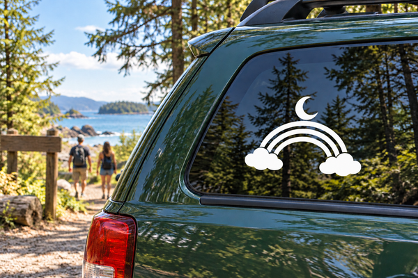 Glow-in-dark vinyl decal: white moon, rainbow arcs, and clouds on car window