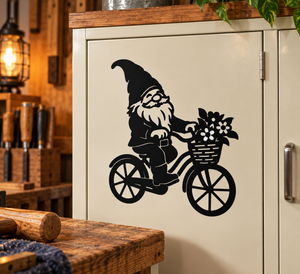 Black gnome vinyl decal riding a bicycle with flower basket on a cabinet door.