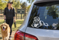Dog ball keeper vinyl decal with black-and-white retriever illustration on car window