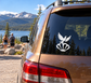 Vinyl dove and shell decal on car rear window, white graphic against dark tint