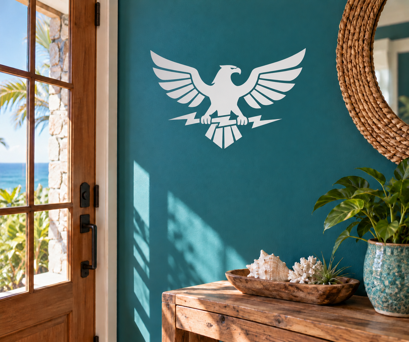 Eagle wings vinyl decal in white, centered on a teal wall