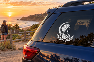 White Greek-style laurel woman head vinyl decal on car window
