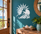 Solar profile vinyl decal of Greek sun-goddess head, white on teal wall.