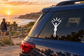 Gymnastics vinyl decal of a silhouetted gymnast under a sunburst on a car window