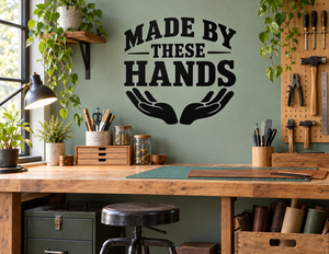 Black vinyl wall decal with "Made by These Hands" text and handprint icon.