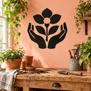 Black vinyl wall decal of hands holding a flower with peach center