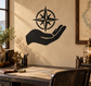 Compass star vinyl decal of a black hand holding a compass on a wall