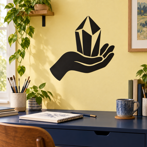 Hand holding crystal vinyl decal, black hand with white crystal on wall