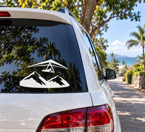 White vinyl decal with hang glider over black mountain silhouettes on car window