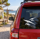 Hang gliding twin-wing vinyl decal on car window, white glider icons on dark glass