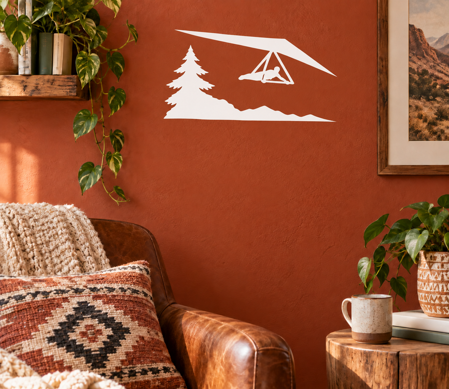 Vinyl hang gliding decal with pine tree and mountain scene, white on orange
