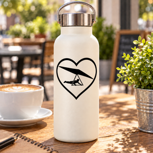 Heart-shaped hang gliding vinyl decal with black glider silhouette on a bottle