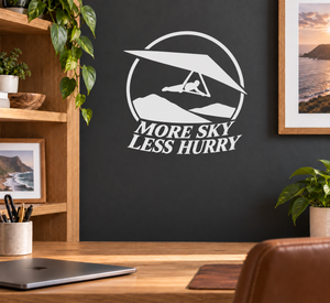 White vinyl hang-glider decal with 'More Sky Less Hurry' lettering