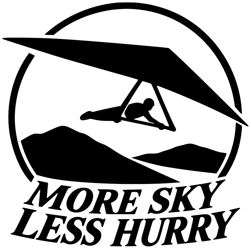 Black-and-white vinyl hang-glider decal with 'MORE SKY LESS HURRY' text