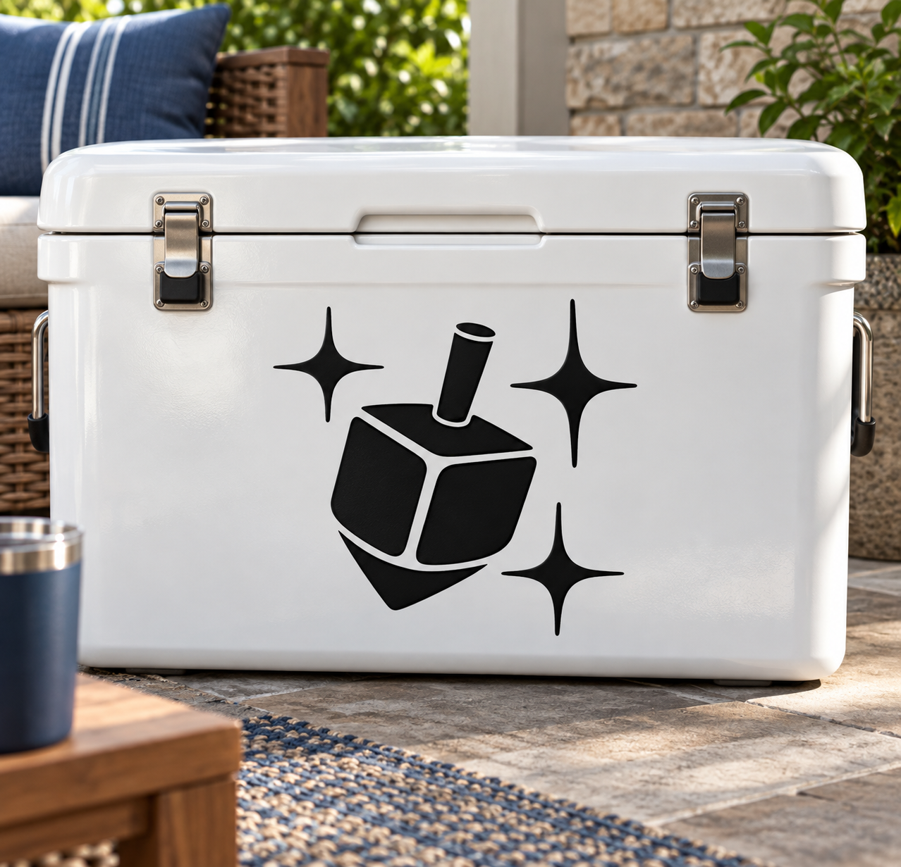 Hanukkah dreidel vinyl decal with black dreidel and starbursts on a white surface