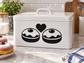 Black and white vinyl decal of two smiling latke faces with a heart above