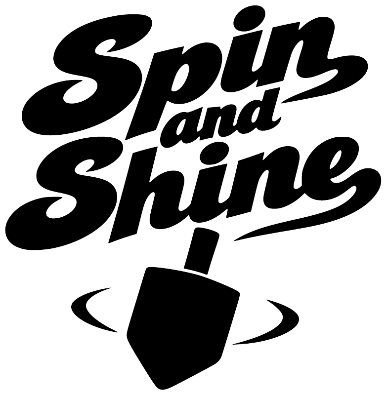 Close-up vinyl decal showing black “Spin and Shine” text with dark cup symbol