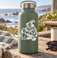 White vinyl decal of a smiling clown holding a puppy and dog on mint bottle