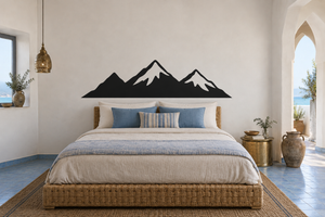 Black mountain horizon vinyl wall decal silhouette above a bed headboard