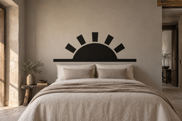 Black sunrise rays vinyl wall decal above a bed headboard