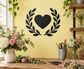 Black heart vinyl wall decal with open laurel wreath design